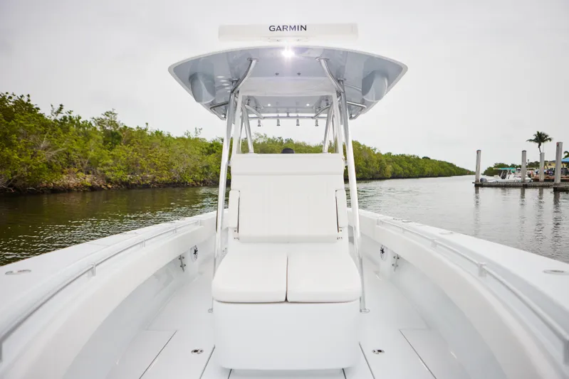  Yacht Photos Pics 2026 Contender 32 ST boat with Garmin equipment on a calm waterway.