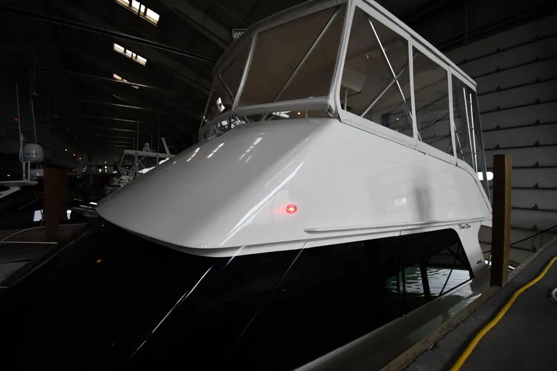 Your Rent's Due Yacht Photos Pics 1996 Viking 50 Convertible yacht docked in a dimly lit marina.