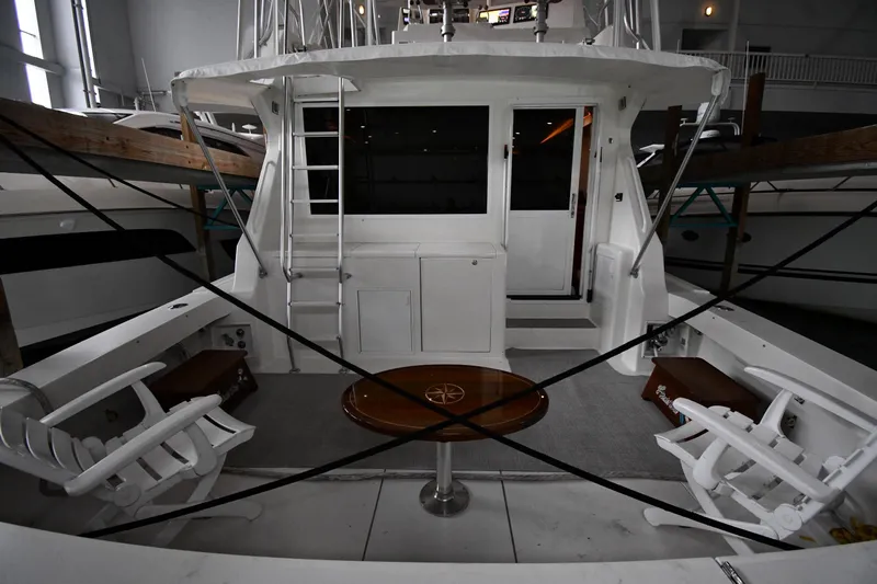 Your Rent's Due Yacht Photos Pics 1996 Viking 50 Convertible yacht interior with seating and table in a marina.