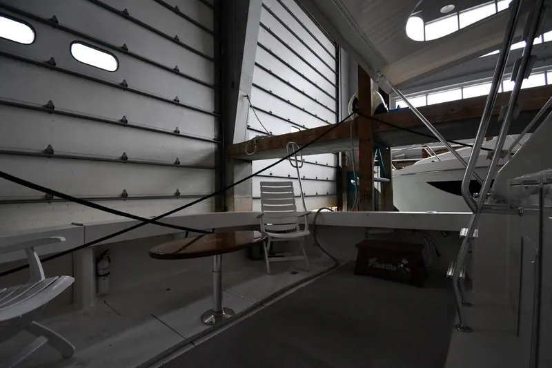 Your Rent's Due Yacht Photos Pics Interior of 1996 Viking 50 Convertible yacht in storage, featuring seating and table.