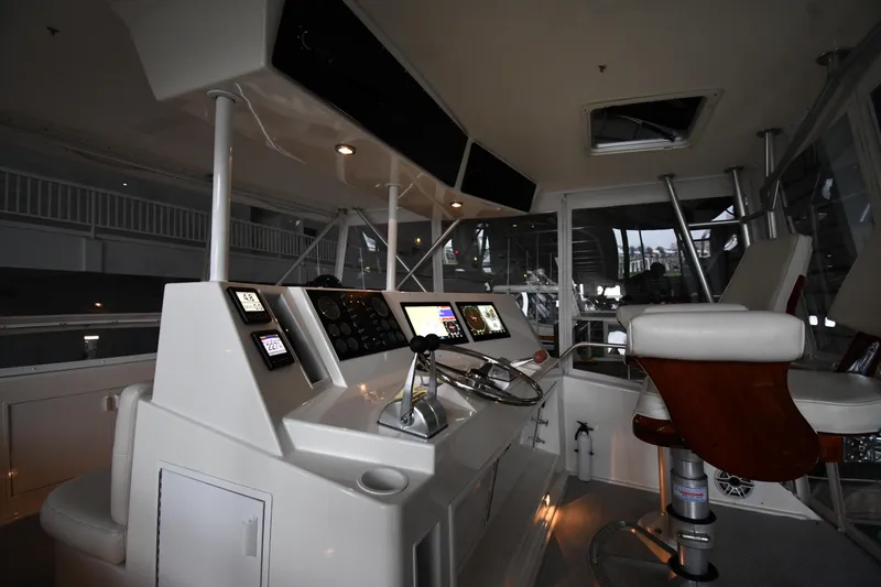 Your Rent's Due Yacht Photos Pics 1996 Viking 50 Convertible yacht helm with modern controls and comfortable seating.