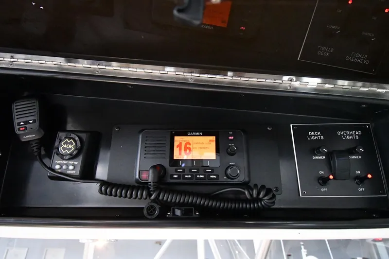 Your Rent's Due Yacht Photos Pics Viking 50 Convertible 1996 boat control panel with Garmin radio and light switches.