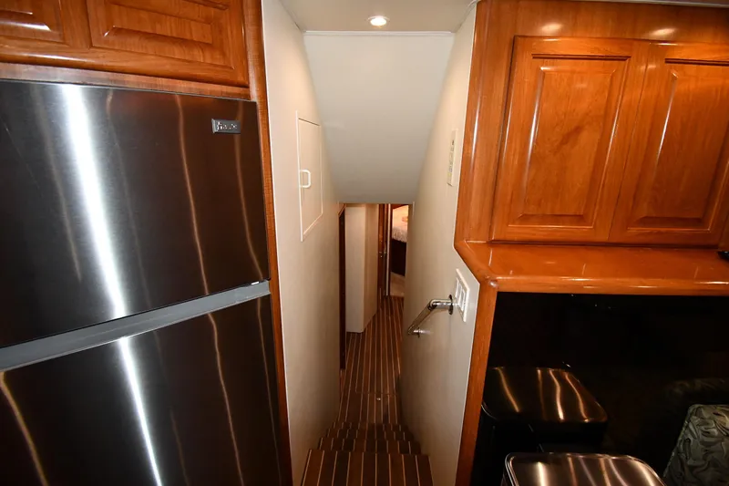 Your Rent's Due Yacht Photos Pics Interior of 1996 Viking 50 Convertible yacht with wooden cabinets and stainless steel appliances.