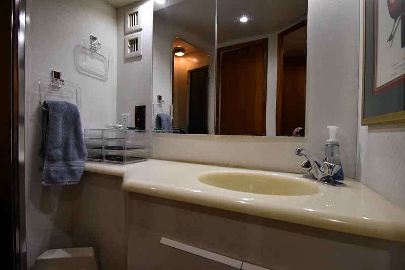 Your Rent's Due Yacht Photos Pics Bathroom interior of 1996 Viking 50 Convertible yacht with sink and mirror.