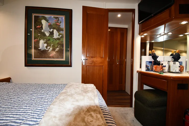 Your Rent's Due Yacht Photos Pics Interior of 1996 Viking 50 Convertible yacht with cozy bedroom and elegant decor.