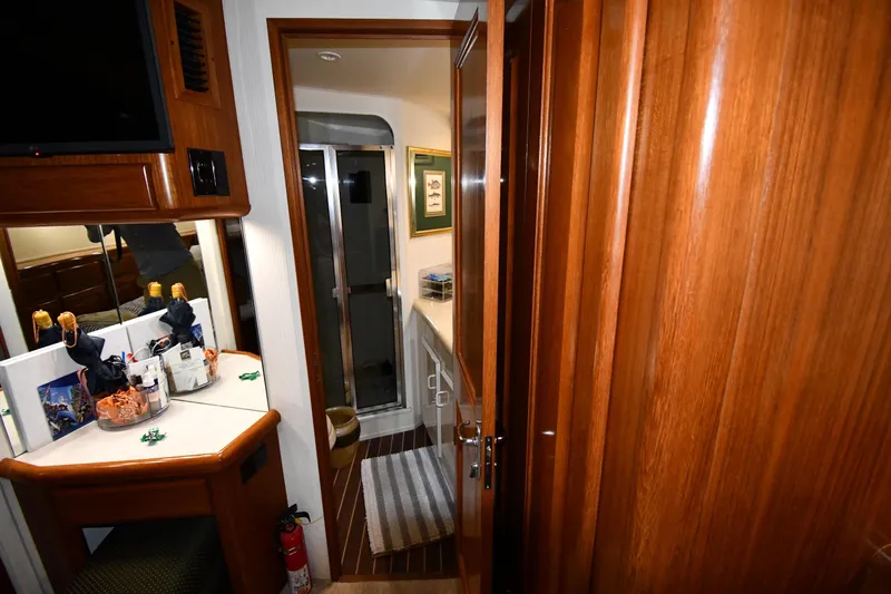 Your Rent's Due Yacht Photos Pics Interior of 1996 Viking 50 Convertible yacht with wooden cabinetry and bathroom view.