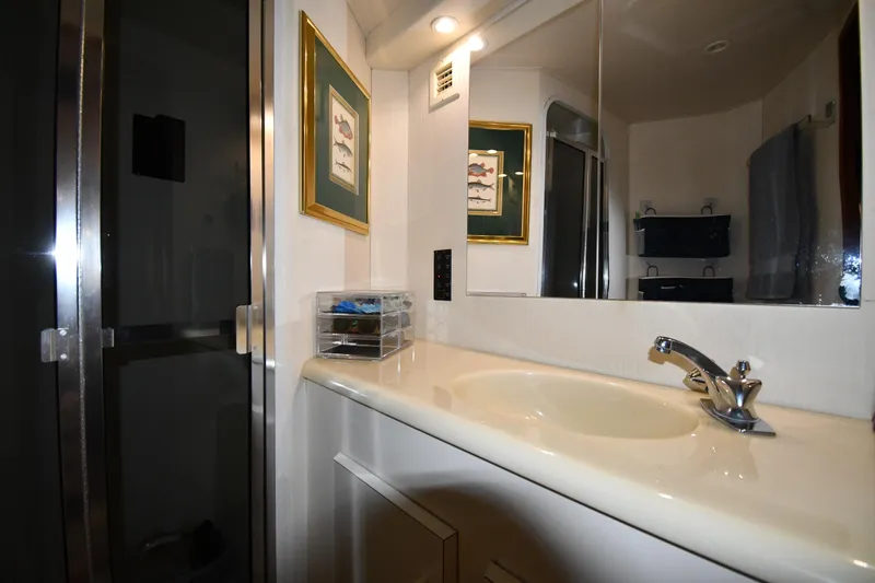 Your Rent's Due Yacht Photos Pics Bathroom interior of 1996 Viking 50 Convertible yacht with sink and mirror.