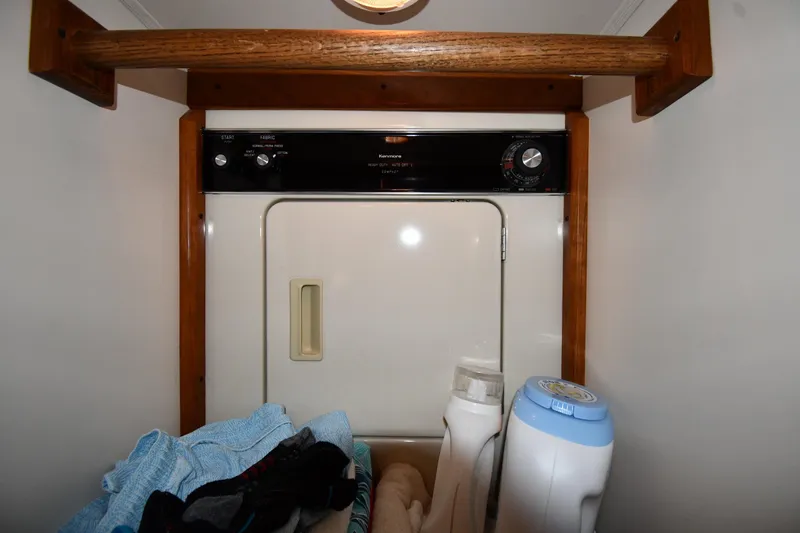Your Rent's Due Yacht Photos Pics Laundry area on a 1996 Viking 50 Convertible boat with dryer and supplies.
