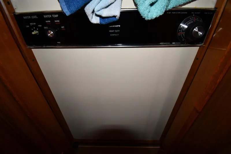 Your Rent's Due Yacht Photos Pics 1996 Viking 50 Convertible interior with laundry controls and towels.