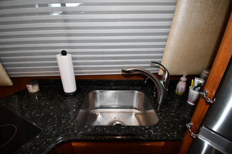 Your Rent's Due Yacht Photos Pics Kitchen sink area in a 1996 Viking 50 Convertible yacht with granite countertop.