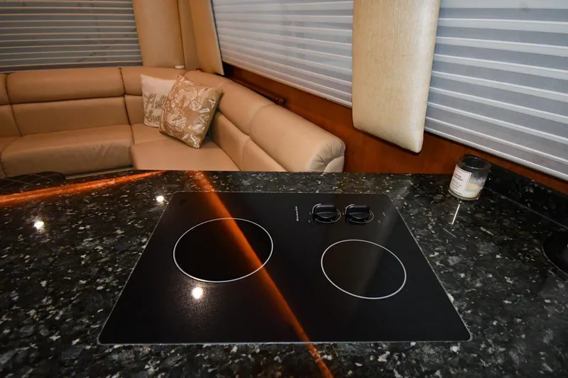 Your Rent's Due Yacht Photos Pics Luxurious interior of 1996 Viking 50 Convertible yacht with modern kitchen and seating area.