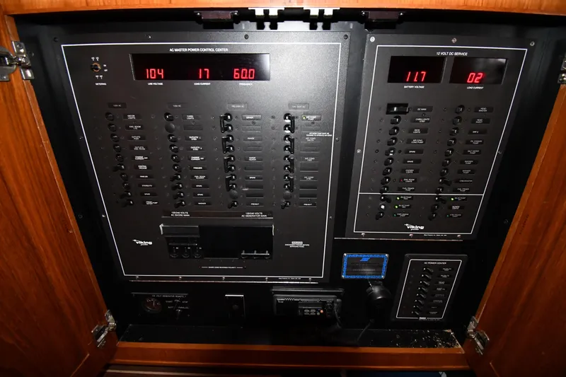 Your Rent's Due Yacht Photos Pics Electrical control panel of a 1996 Viking 50 Convertible boat, featuring various switches and displays.