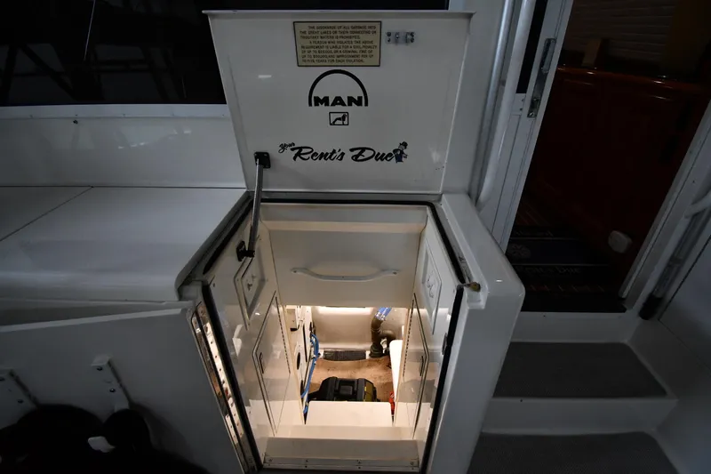 Your Rent's Due Yacht Photos Pics Engine room access on 1996 Viking 50 Convertible yacht, featuring MAN engine branding.