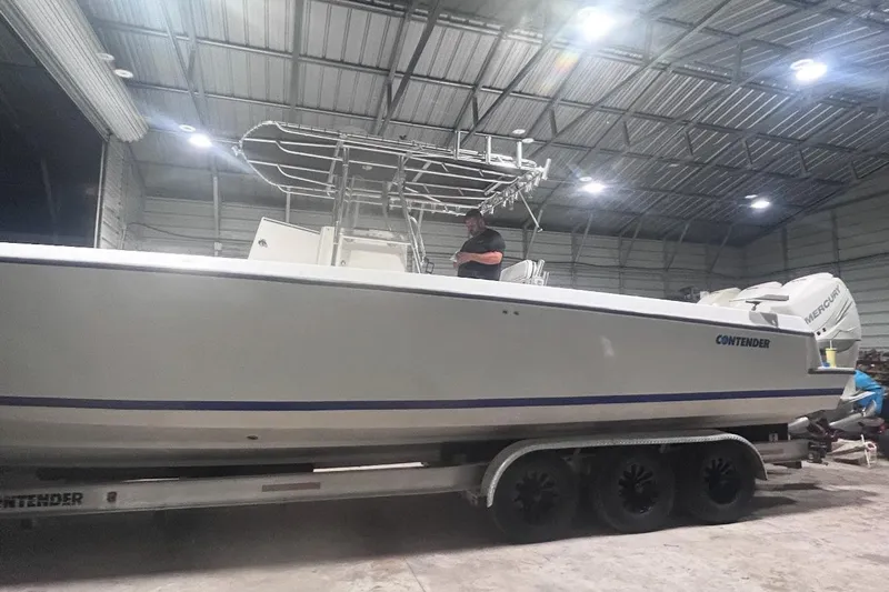  Yacht Photos Pics 2005 Contender 35 ST boat on trailer in a well-lit indoor storage facility.