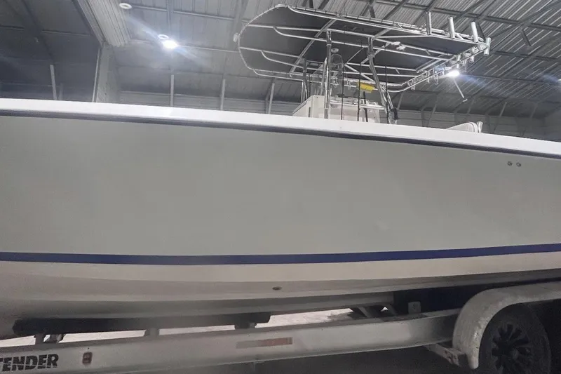  Yacht Photos Pics 2005 Contender 35 ST boat in a warehouse, side view on a trailer.