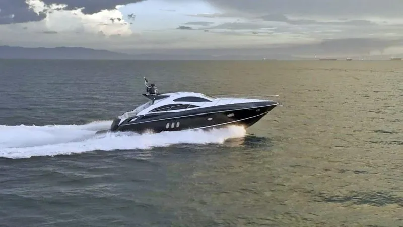  Yacht Photos Pics 2008 Sunseeker Predator 62 yacht cruising on open water at sunset.