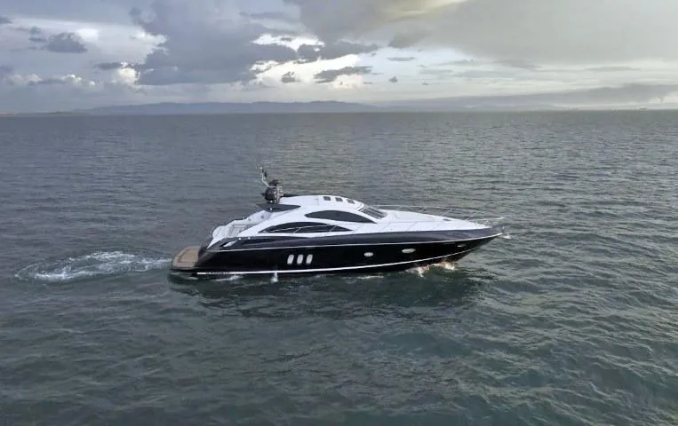  Yacht Photos Pics 2008 Sunseeker Predator 62 yacht cruising on open sea under cloudy skies.