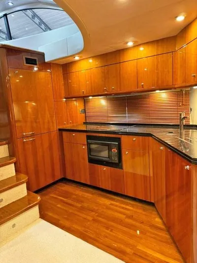  Yacht Photos Pics Luxurious 2008 Sunseeker Predator 62 yacht kitchen with wood cabinetry and modern appliances.