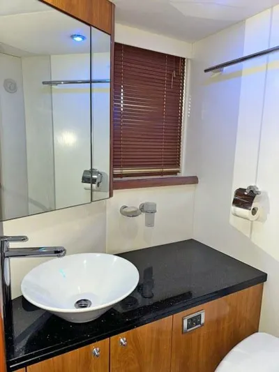  Yacht Photos Pics Luxurious bathroom in 2008 Sunseeker Predator 62 yacht with modern fixtures and sleek design.