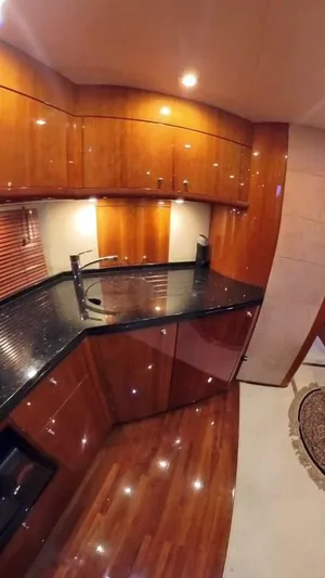  Yacht Photos Pics Luxurious wooden kitchen interior of 2008 Sunseeker Predator 62 yacht.