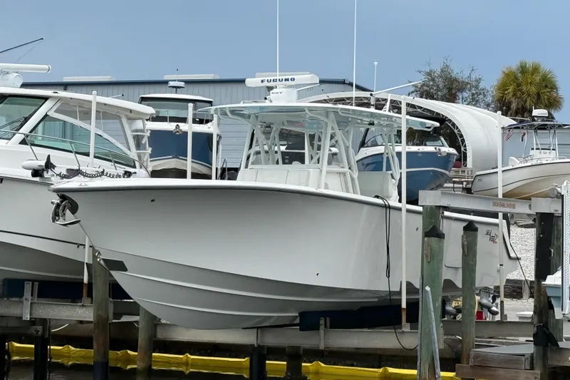  Yacht Photos Pics 2022 SeaVee 270Z boat docked at a marina, surrounded by other vessels.