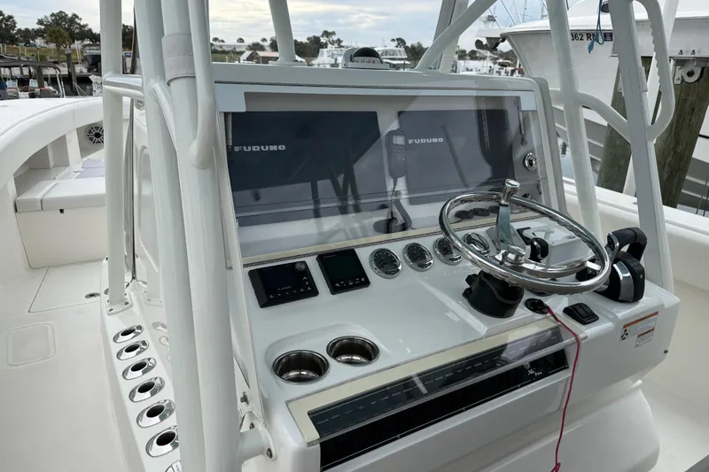  Yacht Photos Pics 2022 SeaVee 270Z boat console with steering wheel and navigation equipment.