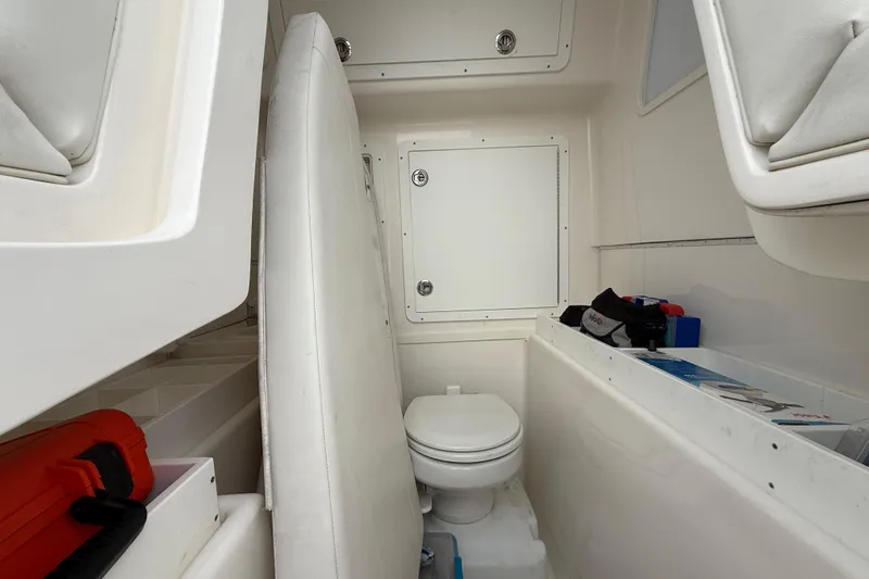  Yacht Photos Pics 2022 SeaVee 270Z boat interior with toilet and storage compartments.