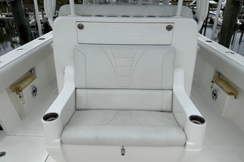  Yacht Photos Pics 2022 SeaVee 270Z boat interior with white cushioned seating and cup holders.