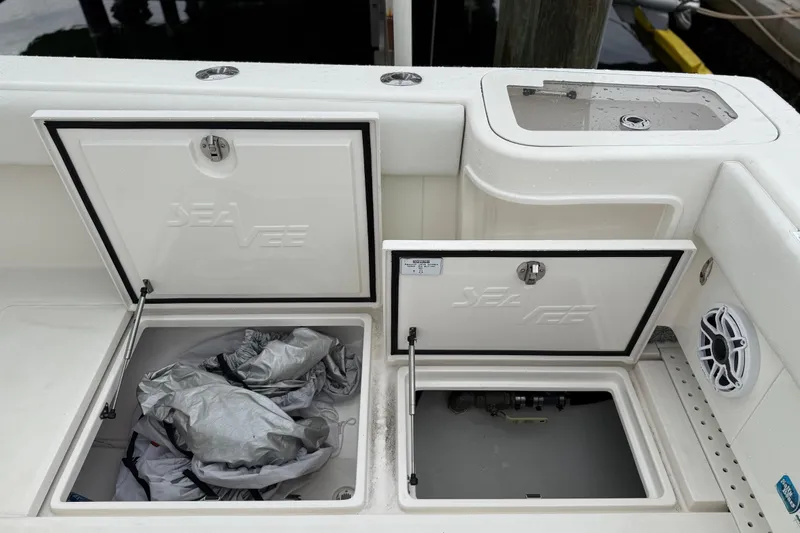  Yacht Photos Pics 2022 SeaVee 270Z boat storage compartments with open hatches and visible speaker.