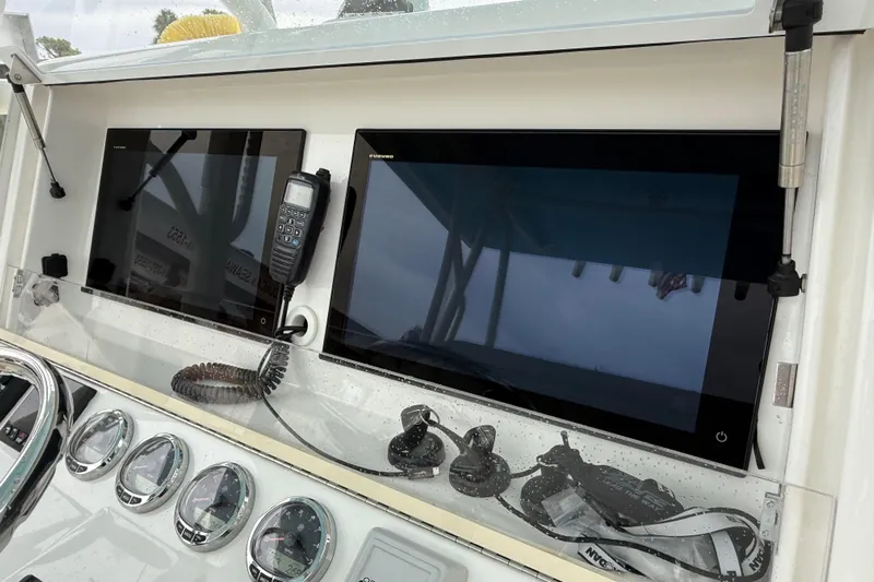  Yacht Photos Pics 2022 SeaVee 270Z boat dashboard with navigation screens and communication equipment.