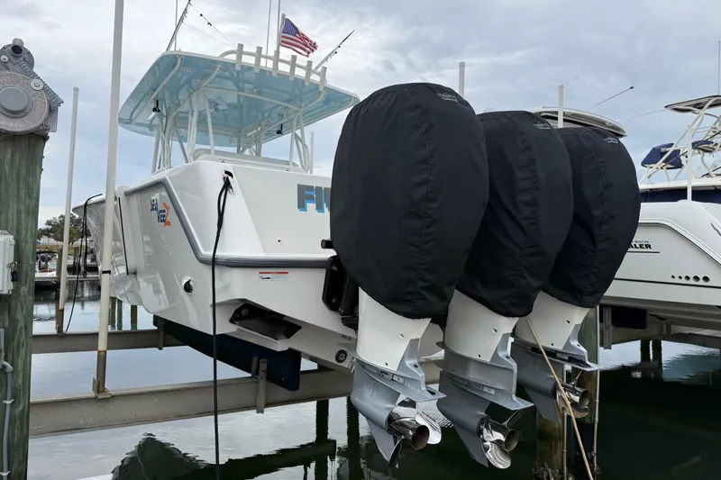  Yacht Photos Pics 2022 SeaVee 270Z boat with triple outboard motors docked at a marina.