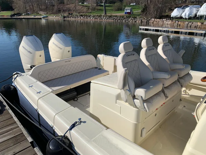  Yacht Photos Pics 2024 Chris-Craft Catalina 34 boat with luxurious seating and twin engines docked by the water.