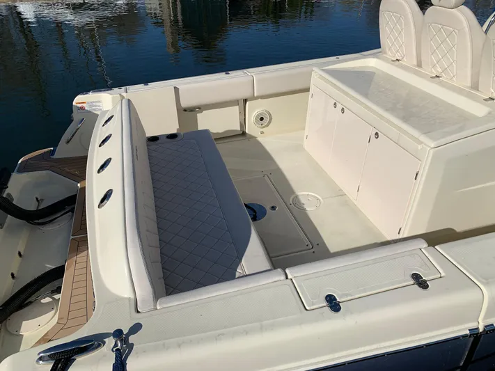  Yacht Photos Pics 2024 Chris-Craft Catalina 34 boat interior with cushioned seating and storage compartments.