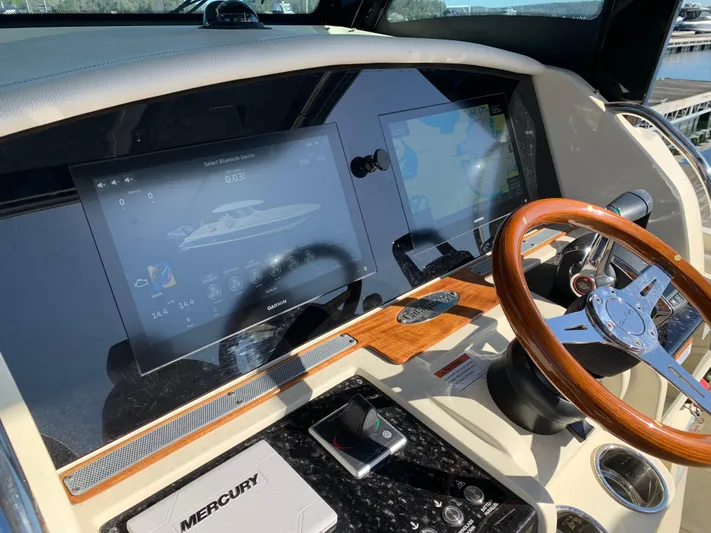  Yacht Photos Pics 2024 Chris-Craft Catalina 34 helm with modern navigation screens and wooden steering wheel.