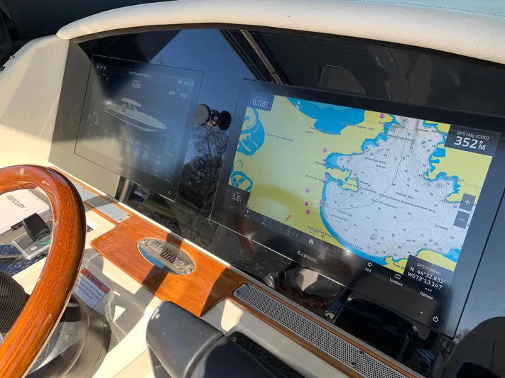  Yacht Photos Pics 2024 Chris-Craft Catalina 34 dashboard with navigation screens and wooden steering wheel.