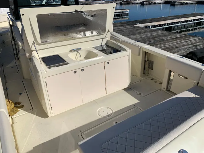  Yacht Photos Pics 2024 Chris-Craft Catalina 34 boat deck with sink and storage, docked at marina.