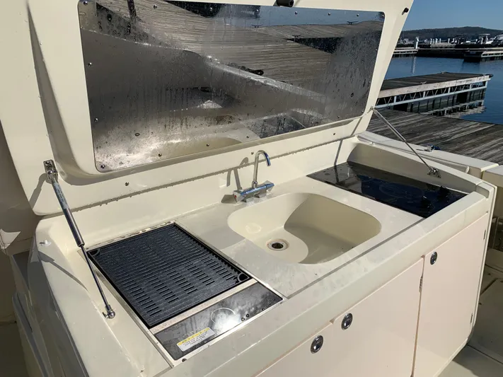  Yacht Photos Pics Outdoor kitchenette on 2024 Chris-Craft Catalina 34 boat with sink and grill.
