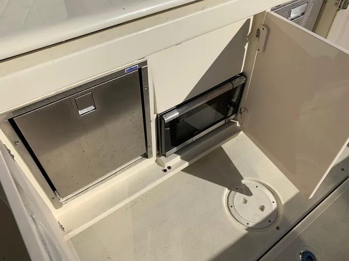  Yacht Photos Pics 2024 Chris-Craft Catalina 34 interior with storage compartments and appliances.