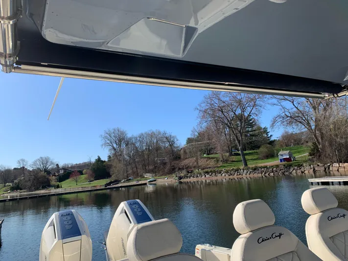  Yacht Photos Pics 2024 Chris-Craft Catalina 34 on a serene lake with scenic shoreline view.