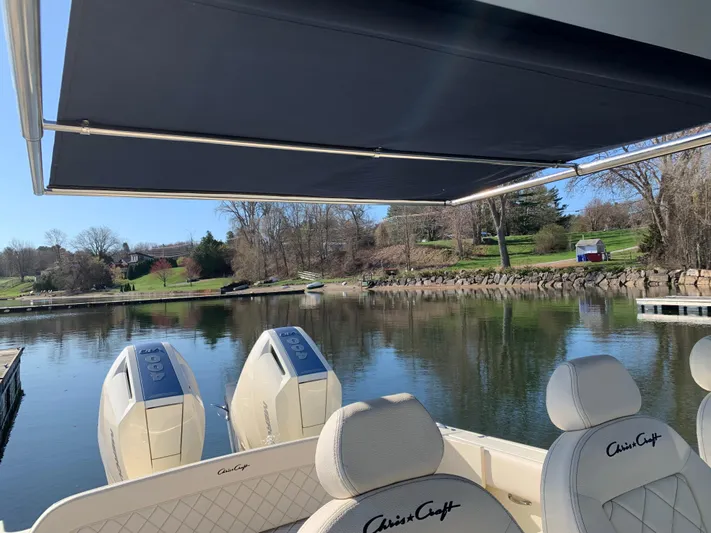  Yacht Photos Pics 2024 Chris-Craft Catalina 34 boat with dual engines, docked on a serene lake.