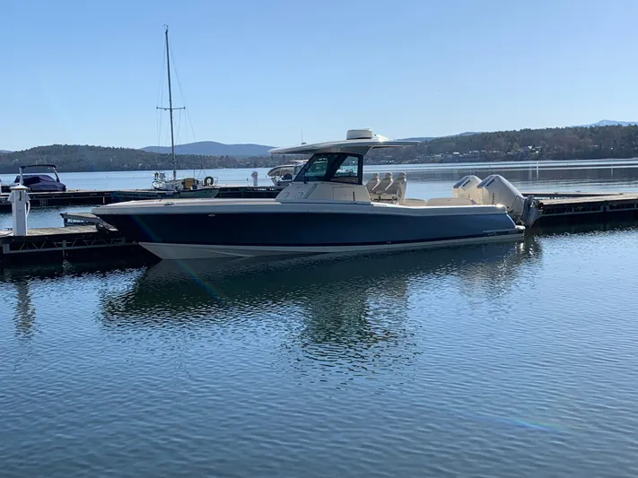  Yacht Photos Pics 2024 Chris-Craft Catalina 34 boat docked on calm water, scenic background.