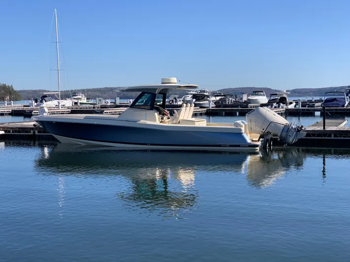  Yacht Photos Pics 2024 Chris-Craft Catalina 34 boat docked in a marina, reflecting on calm water.