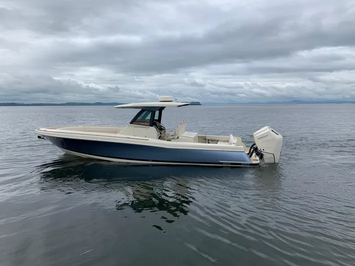  Yacht Photos Pics 2024 Chris-Craft Catalina 34 boat on calm water under cloudy skies.
