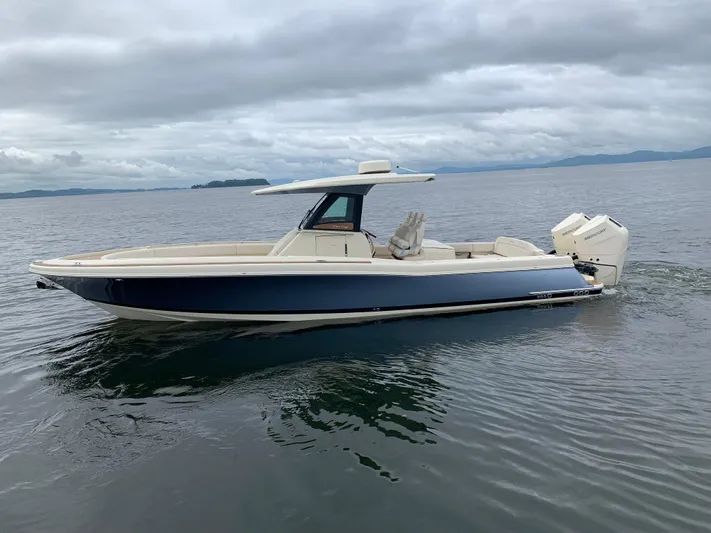  Yacht Photos Pics 2024 Chris-Craft Catalina 34 boat on calm water under cloudy skies.
