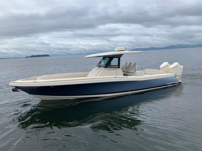  Yacht Photos Pics 2024 Chris-Craft Catalina 34 boat on calm water under cloudy skies.