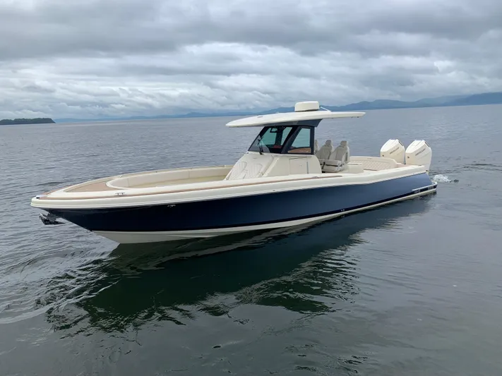  Yacht Photos Pics 2024 Chris-Craft Catalina 34 boat cruising on calm waters under cloudy skies.
