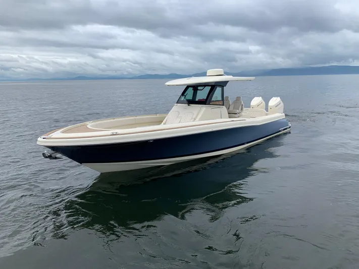  Yacht Photos Pics 2024 Chris-Craft Catalina 34 boat on calm water under cloudy skies.