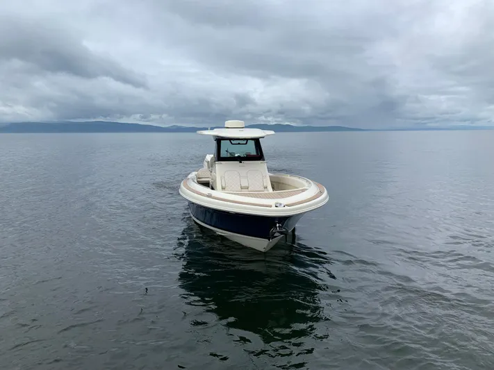  Yacht Photos Pics 2024 Chris-Craft Catalina 34 boat on calm water under cloudy skies.