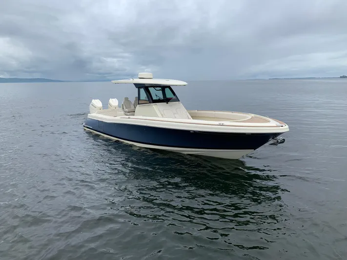  Yacht Photos Pics 2024 Chris-Craft Catalina 34 boat on calm water under cloudy sky.