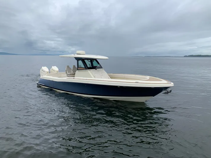  Yacht Photos Pics 2024 Chris-Craft Catalina 34 boat on calm water under cloudy sky.